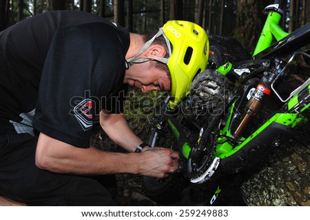 VANCOUVER, CANADA - JUNE 8, 2012: An athlete competes in Adidas Eyeware Chainless Downhill Bicycle Race in the North Shore mountains in North Vancouver, Canada on June 8, 2012.