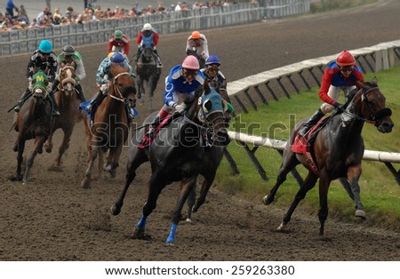 VANCOUVER, CANADA - SEPTEMBER 9, 2014: Horses ridden by jockeys compete at Hastings Park in Vancouver, Canada, on September 9, 2014.