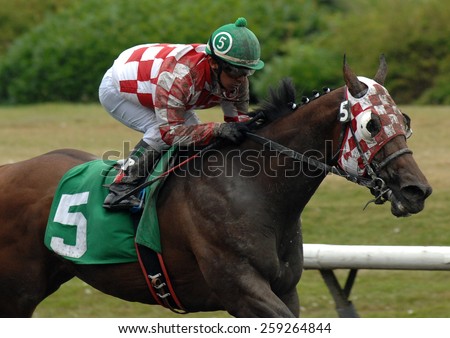 VANCOUVER, CANADA - AUGUST 6, 2012: Horses ridden by jockeys compete at Hastings Park racecourse in Vancouver, Canada, on August 6, 2012.
