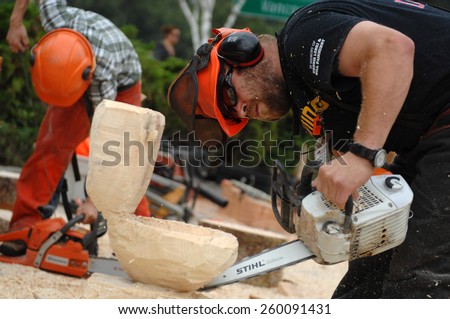 SQUAMISH, BC, CANADA - AUGUST 2, 2013: Loggers demonstrate their chainsaw skills during Squamish Days Loggers Festival in Squamish, BC, Canada, on August 2, 2013.