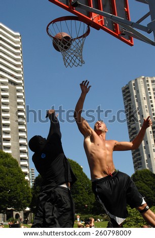 VANCOUVER, CANADA - JULY 29, 2012: Athletes play street basketball at Sunset Beach in Vancouver, Canada, on July 29, 2012.