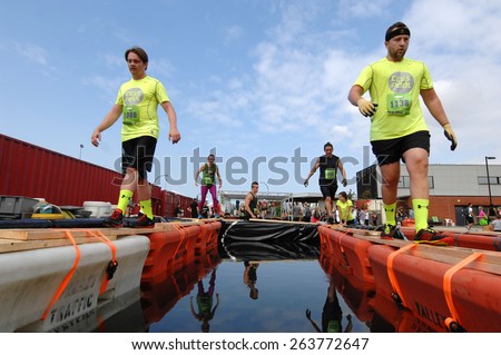 VANCOUVER, CANADA - AUGUST 17, 2014: Runners take part in the annual Concrete Hero obstacle race to raise funds in support of life-saving cancer research in Vancouver, Canada, on August 17, 2014.
