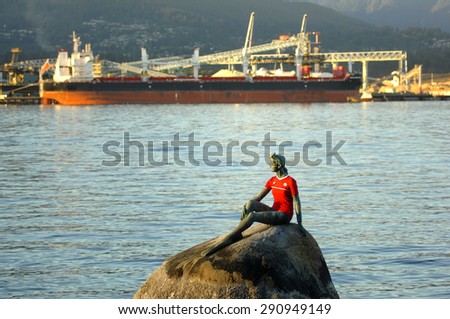 VANCOUVER, CANADA - JUNE 26, 2015: The Girl in a Wetsuit statue sports a Team Canada jersey in honour of upcoming Canada\'s battle at FIFA Women\'s World Cup in Vancouver, Canada, June 26, 2015