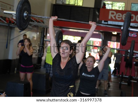 VANCOUVER, CANADA - SEPTEMBER 10, 2011: Athletes show their strength during public event to promote CrossFit sports training in Vancouver, Canada, September 10, 2011.