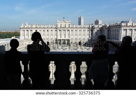 MADRID, SPAIN - OCTOBER 21, 2014: Visitors look at the Royal Palace of Madrid from the Cathedral of Our Lady of Almudena balcony in Madrid, Spain, Oct. 21, 2014.