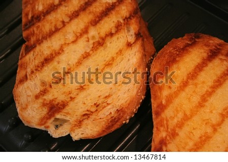 Grilled cheese sandwiches being cooked on electric grill