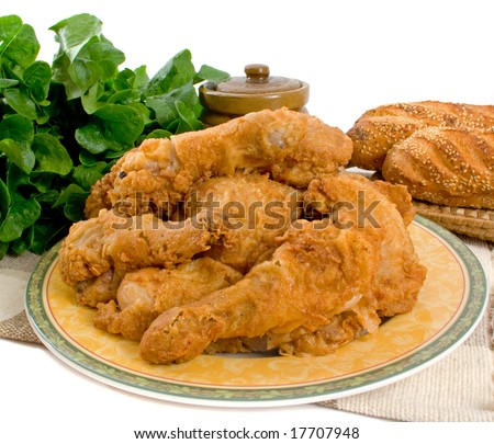 Fried chicken pieces over white background