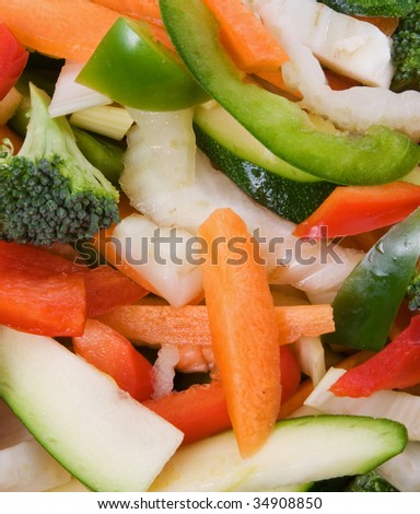Bowl of freshly sliced vegetables for stir fry isolated over white background