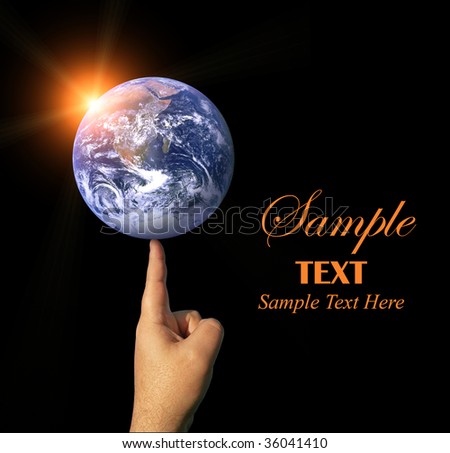 A finger balancing the whole earth with the concepts of environmental awareness and balancing the global economy