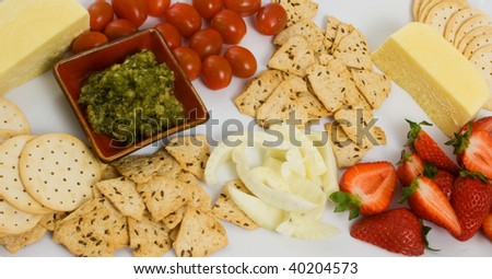 Selection of Savory food with cheese, tomatoes and crackers.