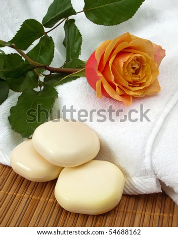 Beautiful apricot rose with three luxury soaps and fluffy white towels
