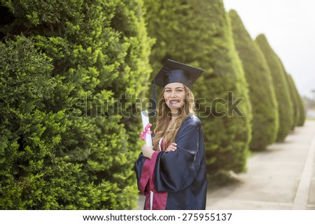 Education theme of happy graduate student girl outdoors