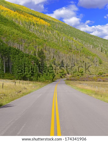 Road Trip in Autumn Foliage: Driving in the Rocky Mountains, USA