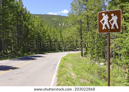 Hiker Crossing sign along road in the Forest