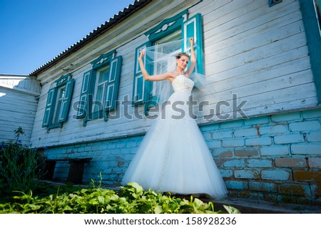 Wedding. Bride near  house in Russian style