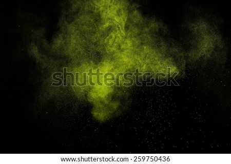 Abstract green paint Holi. Abstract green powder explosion  on black background.