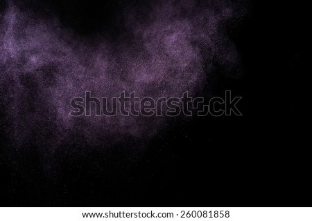 Abstract purple  paint Holi. Abstract purple powder explosion on black background.