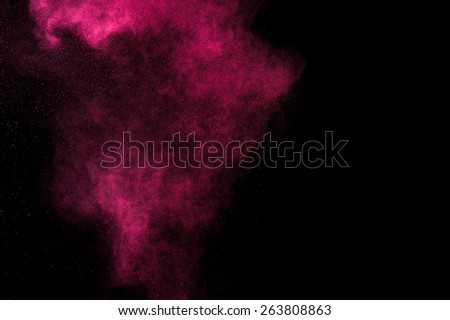 Abstract red and pink paint Holi. Abstract red and pink powder explosion on black background.