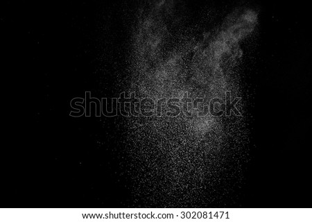 abstract white dust explosion  on a black background. abstract white powder. design elements. abstract texture.