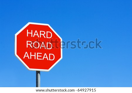 Hard Road Ahead road sign against a clear blue sky