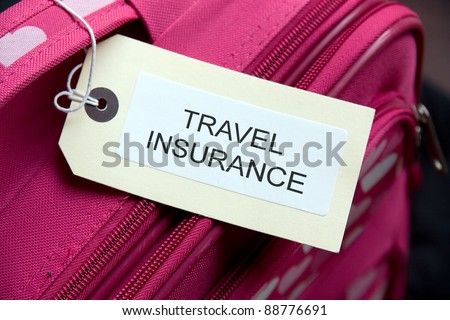 Travel Insurance label tied to a suitcase