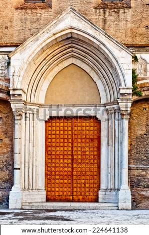 Old wooden church door. Entrance to the church San Francesco Bologna Italy