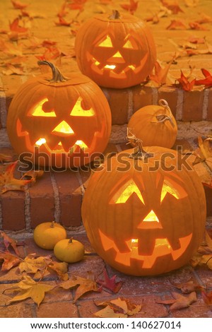 Halloween Jack-O-Lanterns are lit at night