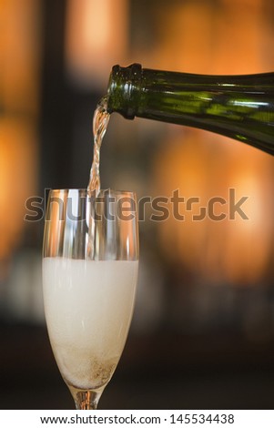 pouring French champagne into glass flute