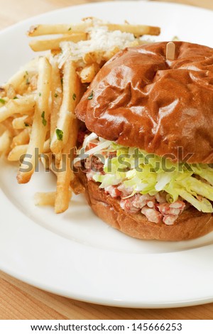 lobster roll sandwich with french fries, close-up