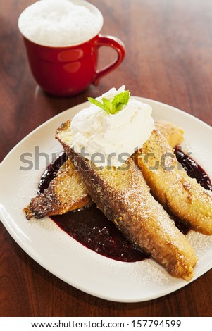 vanilla-dipped French toast with whipped cream and berry syrup with coffee
