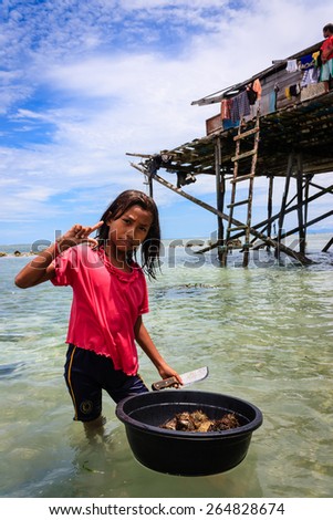 May 5 2011- Mabul Island, Malaysia - Sama-Bajau\'s people hunting sea urchin for family food. They are are traditionally from islands of the Sulu Archipelago in the Philippines.