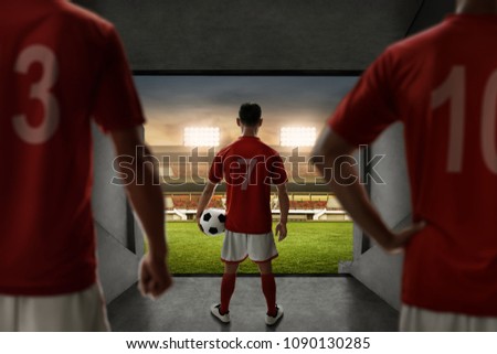 Soccer players team standing on stadium entrance