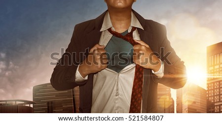 Businessman Superhero in city building at sunset