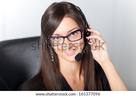 support phone operator in headset at workplace