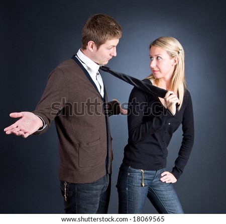 woman pulling a man by a necktie