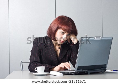Got tired Beautiful businesswomen behind a desktop and a laptop