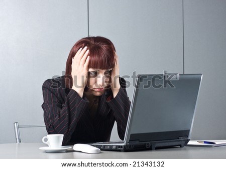 Got tired Beautiful businesswomen behind a desktop and a laptop