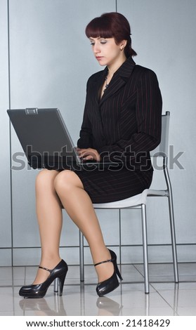business woman sitting on chair with laptop