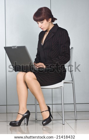 business woman sitting on chair with laptop