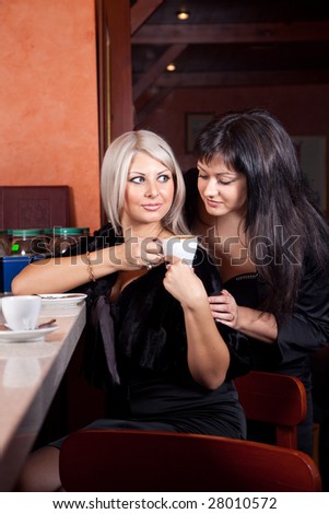 two Beautiful  woman  at bar in cafe