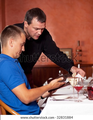 The waiter brings bill at restaurant.