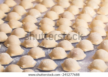Homemade raw pastry dumplings with meat filling called pelmeni