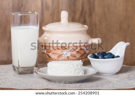 Fresh blueberries and milk products on wooden table