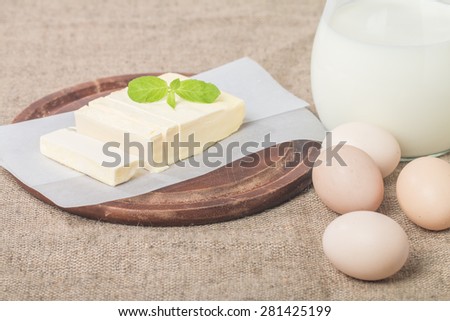 Butter on sheet of paper on burlap background