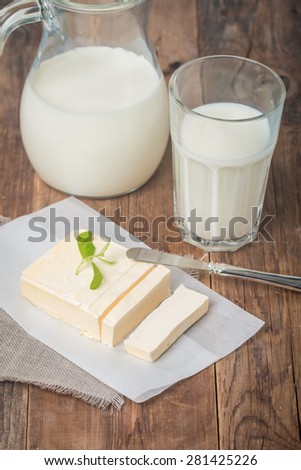 Butter on sheet of paper on  wooden background
