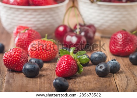 Berries mix in bowl on rustic background