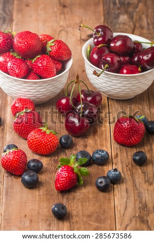 Berries mix in bowl on rustic background