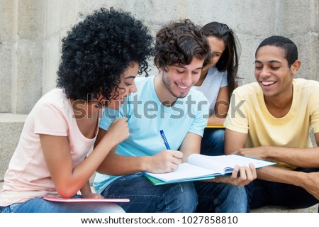 Group of american students learning outdoors on campus in summer