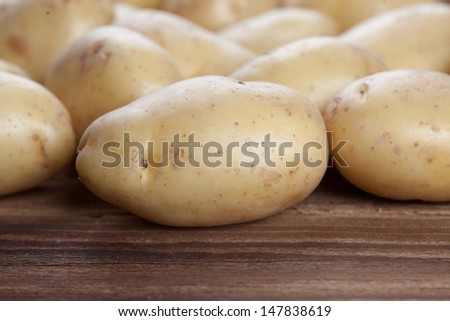 Big potatoes on wood