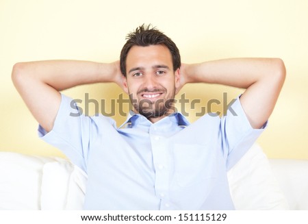 Smiling latin man on white couch